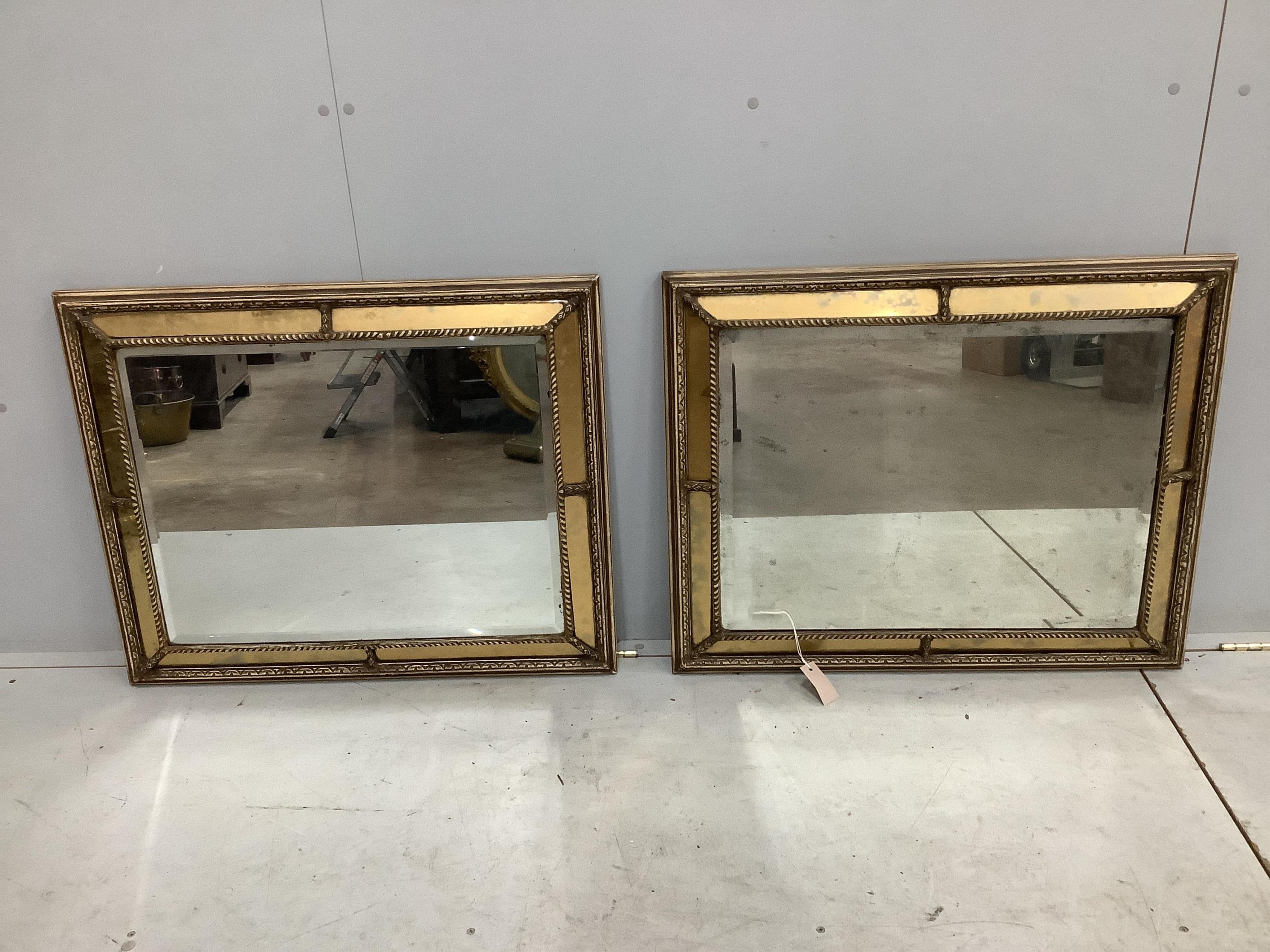 A pair of Regency style rectangular giltwood and composition marginal plate cushion framed mirrors, width 66cm, height 83cm. Condition - fair to good